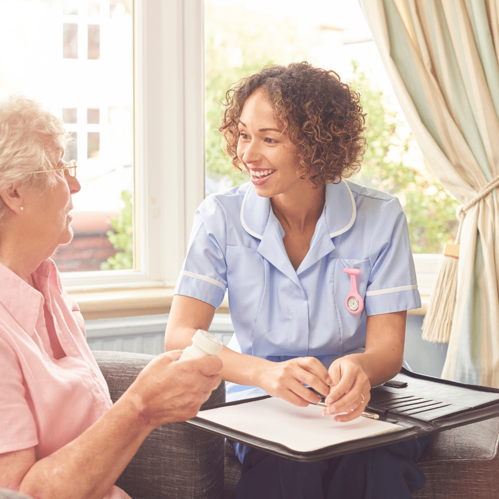 Care professional at Concept Care Community Services discussing care plans with an elderly woman, emphasising personalised home care services.